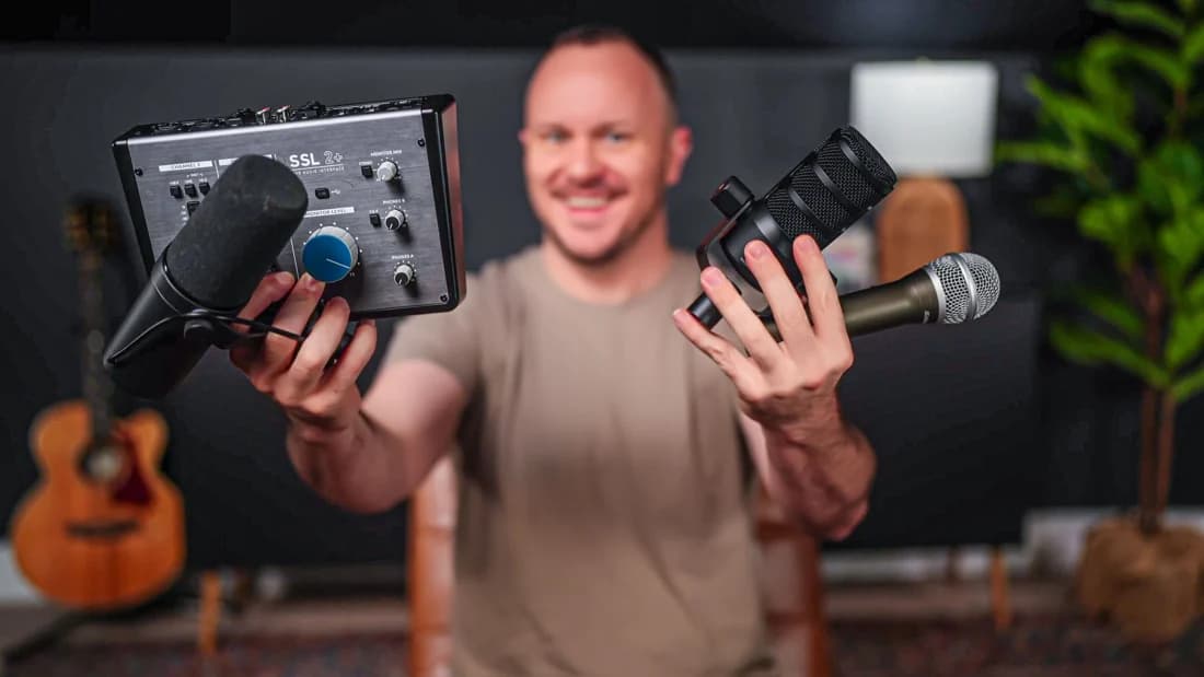 Stephen holding recording equipment in his studio